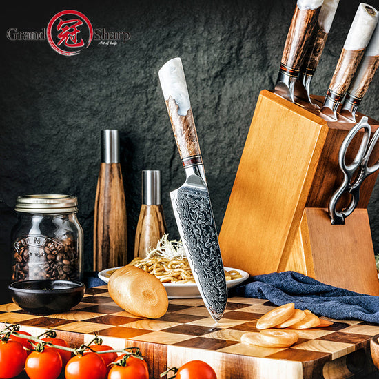 The Damara Chisai Damascus paring knife stuck in a checkered cutting board next to ingredients like tomatoes and noodles.