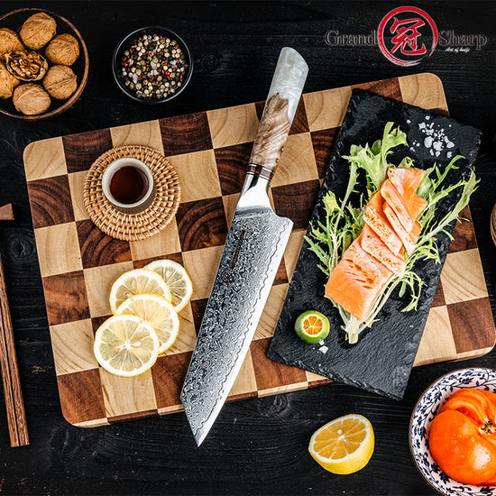 Damara Taisho 8 inch Damascus Kiritsuke knife presenting sliced salmon on a slate board