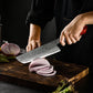 A chef’s hands using the Damara Ryujin Kiritsuke knife to slice a red onion on a wooden cutting board.