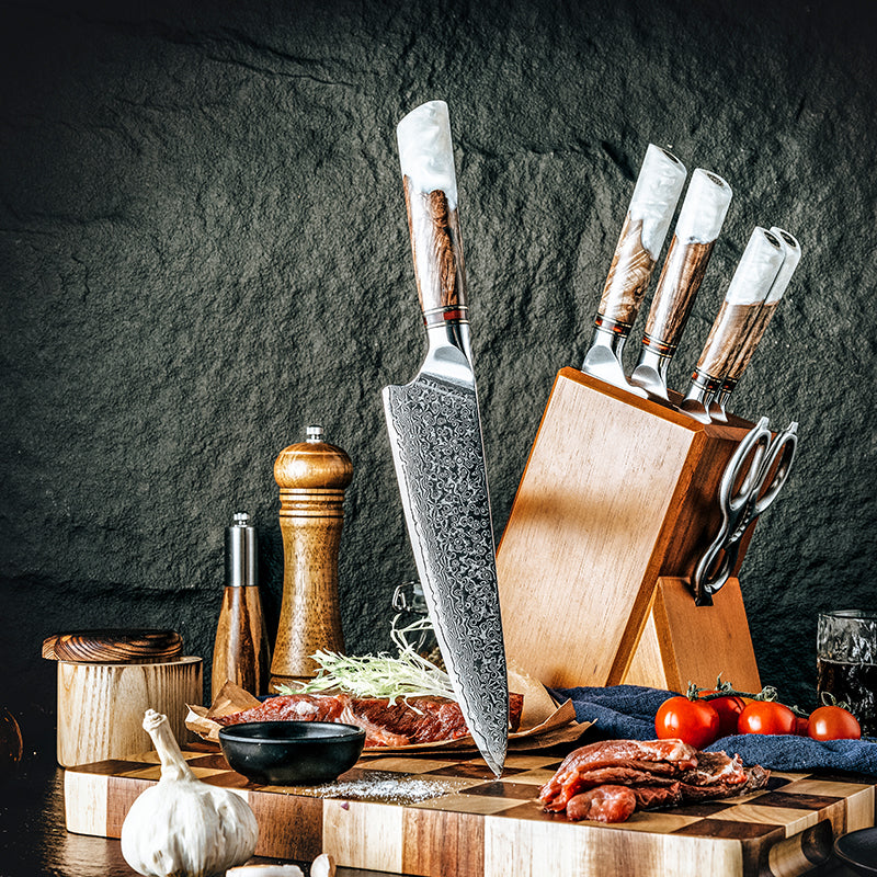 Close-up shot of the elegant handle of the ‘Kaku’ chef’s knife, showing the white resin swirls and natural wood grain.
