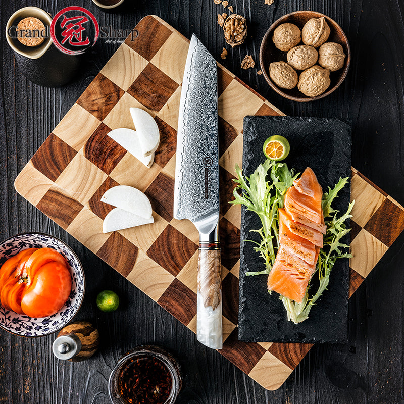Top down view of Damara Taisho Kiritsuke knife on wooden board with sliced vegetables
