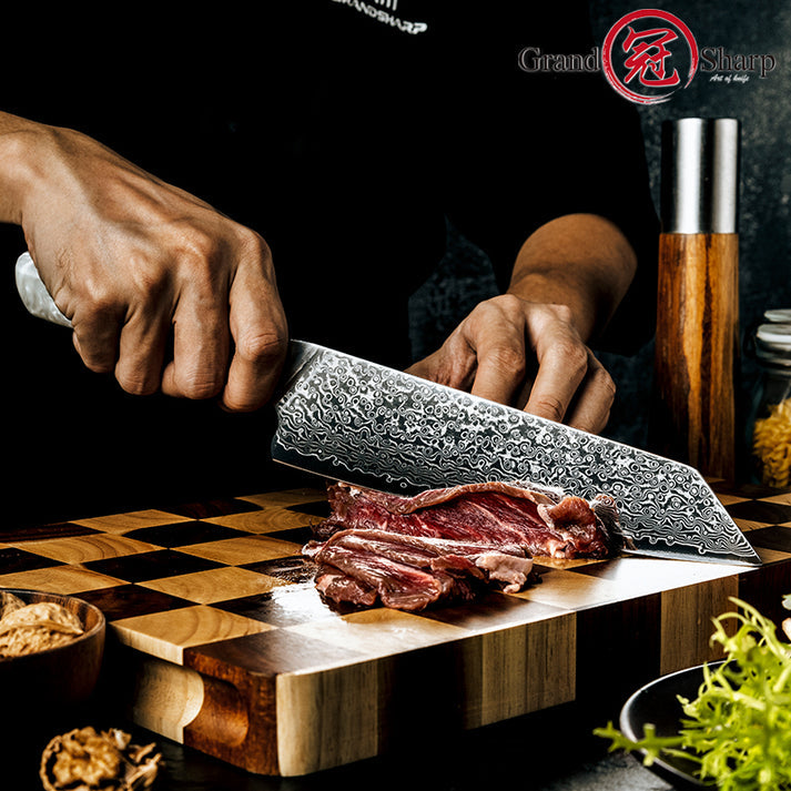 Chef slicing raw beef steak with Damara Taisho Damascus Kiritsuke knife
